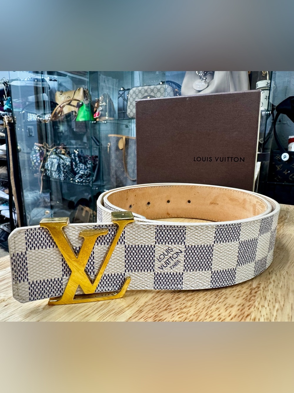 Louis Vuitton Damier Azur belt with gold buckle.